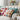 grandmillennial style interior decor with a sofa covered in crocheted pillows